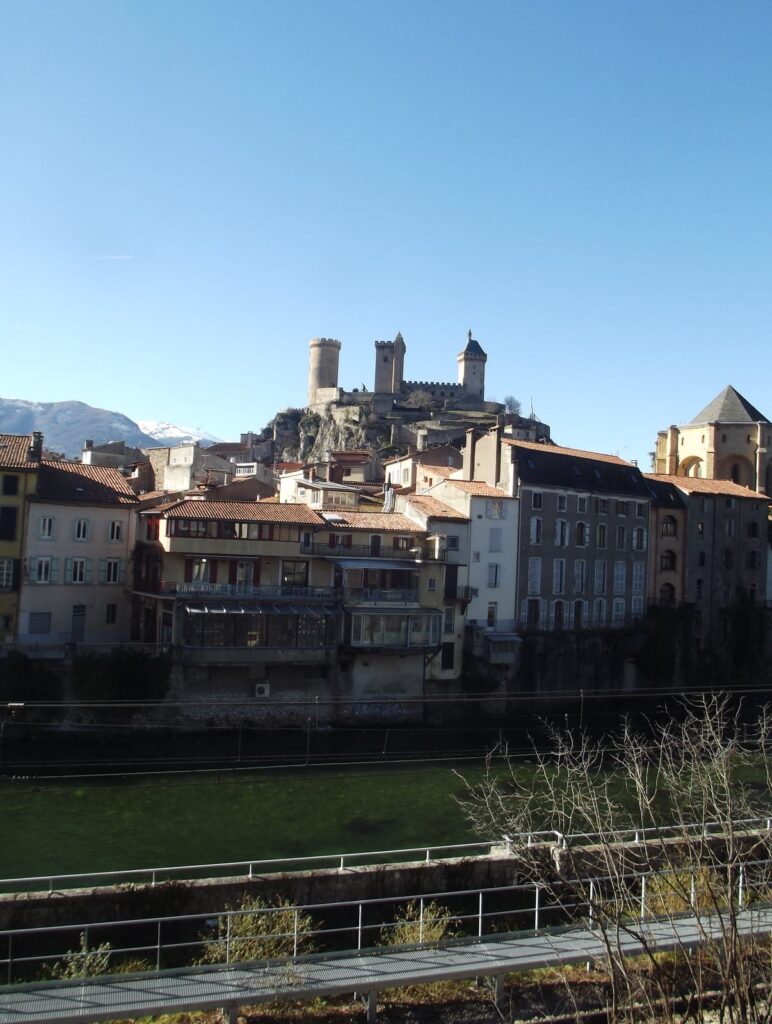 Le Château de Foix sur sa colline, avec l'Ariège et la voie ferrée en contrebas.